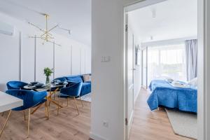 a living room with a blue couch and a table at Apartment105 Westin House Resort in Kołobrzeg