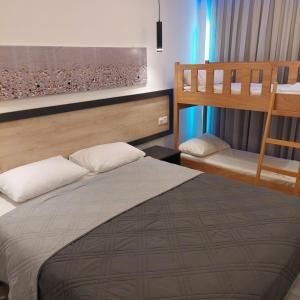 a bedroom with two bunk beds and a bed at Papouis Protaras Hotel in Protaras