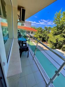 a balcony with a table and a swimming pool at DebiMar in Chernomorets