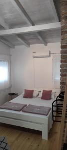 a bedroom with a large bed in a room at Hotel & Rooms Lombrelle in Mostar