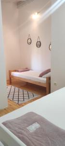 a bedroom with two beds in a room at Hotel & Rooms Lombrelle in Mostar