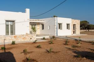 a white house with a yard in front of it at Santa Maria Mare in Naousa