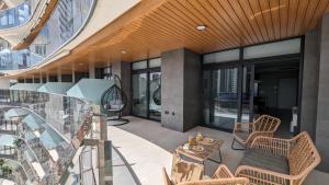 a balcony of a building with a table and chairs at SUNSET WAVES sun & beach apartments in Benidorm