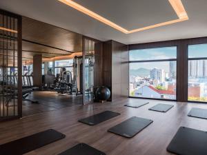 a yoga room with a view of a city at Bay Capital Danang in Danang