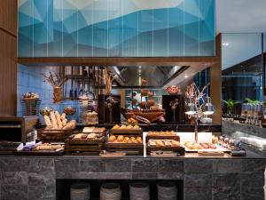 a bakery counter with pastries and breads on display at Bay Capital Danang in Da Nang