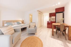 a living room with a bed and a dining room at Bravissimo Plaça Catalunya 1-2, Studio apartment in Girona
