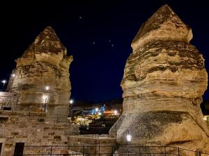 two large stone towers at night at Peruna Cave in Goreme