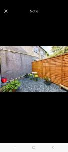 a backyard with a fence and a table and chairs at The Snug in Cockermouth