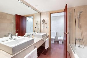 a bathroom with a sink and a shower and a toilet at Hotel Cristina by Tigotan Las Palmas - Adults Only in Las Palmas de Gran Canaria