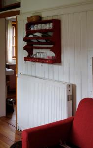 a living room with a red couch and a wall at Apartment bei der Tischlerei in Deutschlandsberg