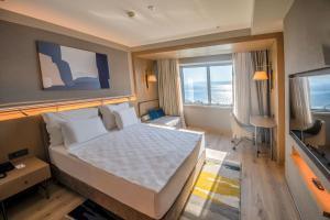Postel nebo postele na pokoji v ubytování Kolin Hotel Spa & Convention Center
