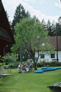 eine Gruppe von Menschen, die in einem Garten mit Trampeln sitzen in der Unterkunft Apartment bei der Tischlerei in Deutschlandsberg