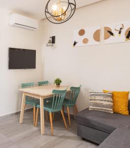 a dining room with a table and chairs and a couch at Accommodation Apartments In The Heart Of The Nachlaot Neighborhood in Jerusalem