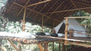 einen Holztisch mit Strohdach in der Unterkunft Ella Retreat Glamping Bell Tent For Nature Lovers in Ella