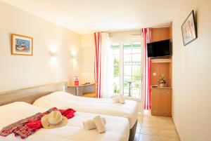 Ein Bett oder Betten in einem Zimmer der Unterkunft Azureva Hendaye