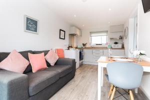 a living room with a couch and a kitchen at Jack's Hideaway in Gatehouse of Fleet