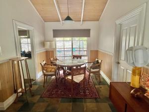 a dining room with a table and chairs at Kookaburra Cabin in Warburton