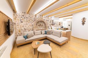 a living room with a couch and a table at Domus Inn Luxury Apartments in Parga