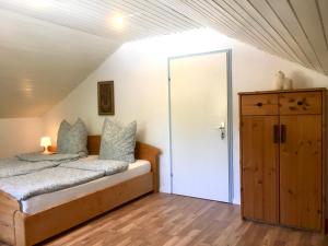 a bedroom with a bed and a closet at Swiss View in Hohentengen