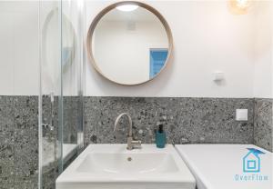 a bathroom with a sink and a mirror at Whizzy Room in Gdańsk