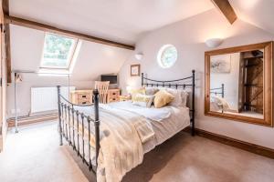 a bedroom with a bed and a mirror at The Old Coach House, Leiston in Leiston