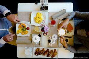 a group of people standing around a table with food at LHP Hotel Montecatini Palace & SPA in Montecatini Terme