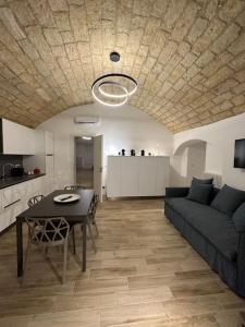 a living room with a couch and a table at Mediterranean House in Bari