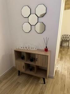 a room with a table with a mirror on the wall at Mediterranean House in Bari