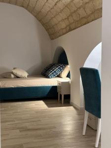 a bedroom with a bed and a chair in a room at Mediterranean House in Bari