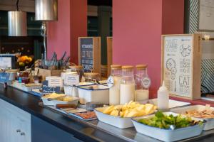 a buffet line with food and other food items at ibis Orléans Nord Saran in Saran