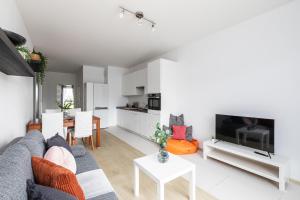 a living room with a couch and a tv at SuperApart Mińska apt91 in Warsaw