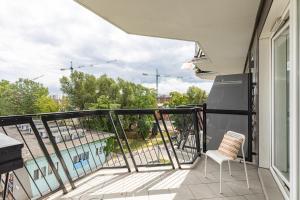 a balcony with a view of a pool at SuperApart Mińska apt91 in Warsaw