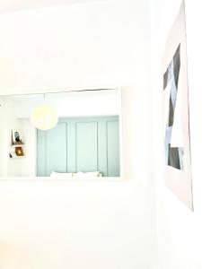 a room with white walls and a mirror at Central Old city 1 in Bucharest