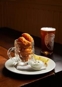 a glass mug with food and a drink on a table at The Sherborne Arms in Northleach