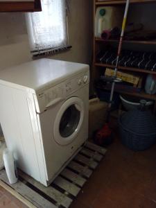 a washer and dryer sitting in a room at SOLELUNA in Carro