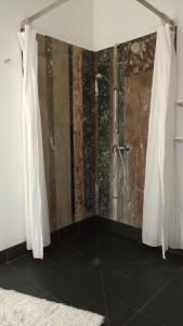a bathroom with a shower with a shower curtain at B&B Oostende in Ostend