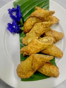 a plate of food with fried food on a plate at Khao Sok Green Mountain View in Khao Sok National Park