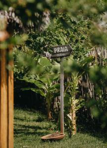 a street sign on a pole in the grass at VILA ATY LODGE in Atins +61 photos