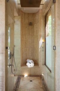 a bathroom with a shower with two rolls of towels at Molori Safari in Derdepoort