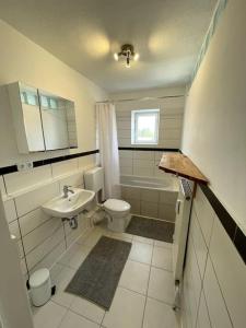 a bathroom with a toilet and a sink at Homestay - Luxus Ferienwohnung in Bad Griesbach