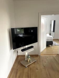 a living room with a large flat screen tv on a wall at Homestay - Luxus Ferienwohnung in Bad Griesbach