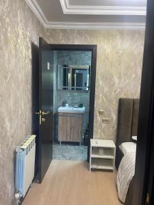 a bathroom with a sink and a mirror at Hotel LION Almaty in Almaty