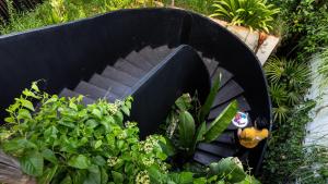 a black boat with a bird sitting in it at Lynnaya Urban River Resort in Siem Reap