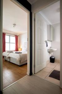 an open door to a bedroom with a bed at The Rondebosch in Cape Town