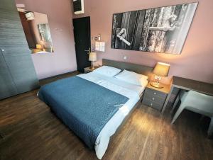 a bedroom with a bed and a desk and a sink at Nitro Rooms in Ljubljana
