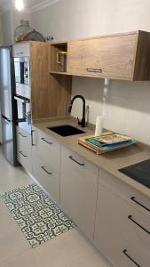 a kitchen with a sink and a refrigerator at Casa Sanjurjo in Monforte de Lemos +14 photos
