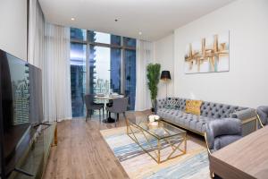 a living room with a couch and a table at LUXURY 1 BR Apartment at Marina Gate Jumeirah Living in Dubai