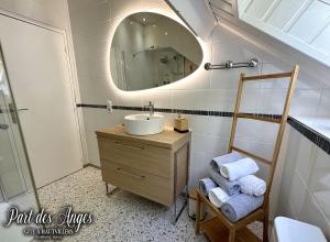 La salle de bains est pourvue d'un lavabo et d'un miroir. dans l'établissement Part des Anges - Gîte Hautvillers, à Hautvillers