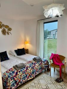 a bedroom with two beds and a window at Osada Zaborek in Janów Podlaski +155 photos