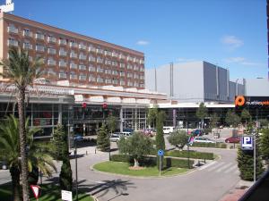 a large building with a parking lot in front of it at Aparthotel Albufera in Alfafar